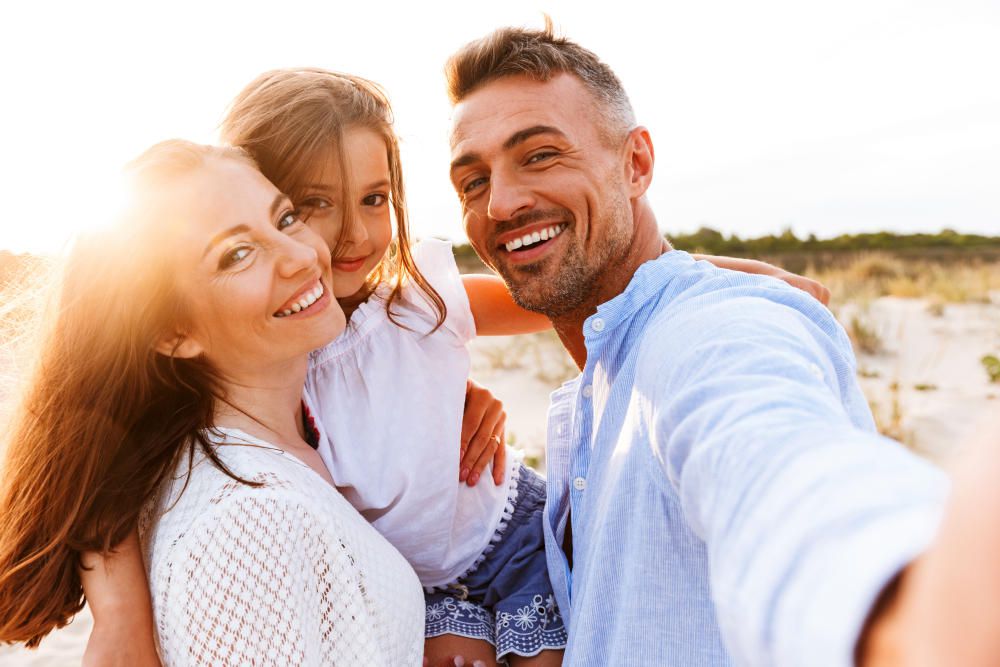 Happy family spending good time at the beach together, taking selfie | Outstanding Time Management Strategies For Bookkeepers | time management worksheet