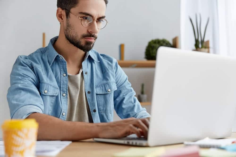 Serious male model wears denim shirt and glasses | How to Multitask As A Work From Home Parent | time management