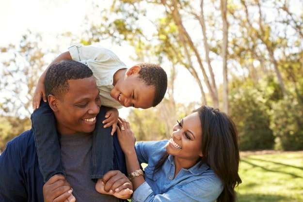 Parents Carrying Son On Shoulders As They Walk In Park | Reasons Why Virtual Bookkeeping Is A Great Job For Stay At Home Moms | virtual bookkeeping jobs part time