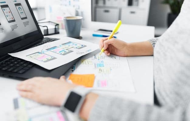 a man designing and drawing web at the table ca