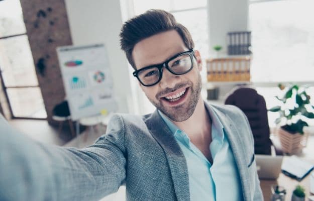 a man in suit taking selfie ca