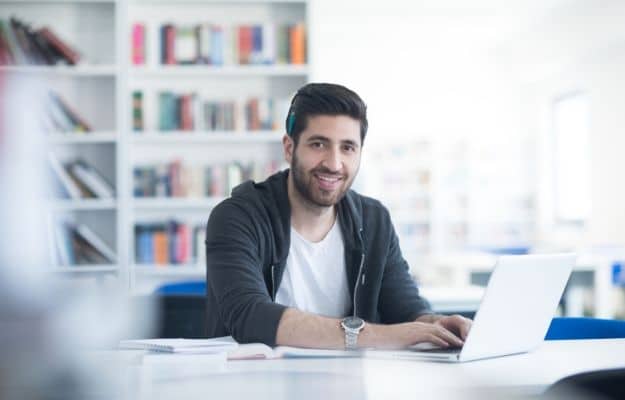 Student preparing exam and learning lessons in school library ss