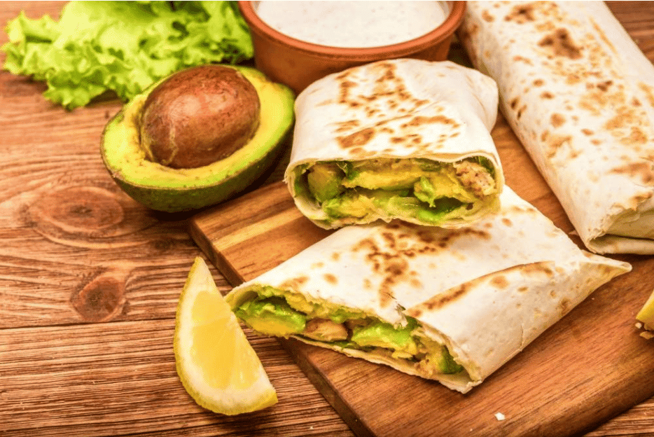 Chicken, avocado and vegetables burrito on the wooden background | Quick and Healthy Lunch Recipes To Make While Working From Home | quick lunch ideas for work