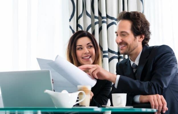 A man and a women are happily dicussing and poiting at the documents CA