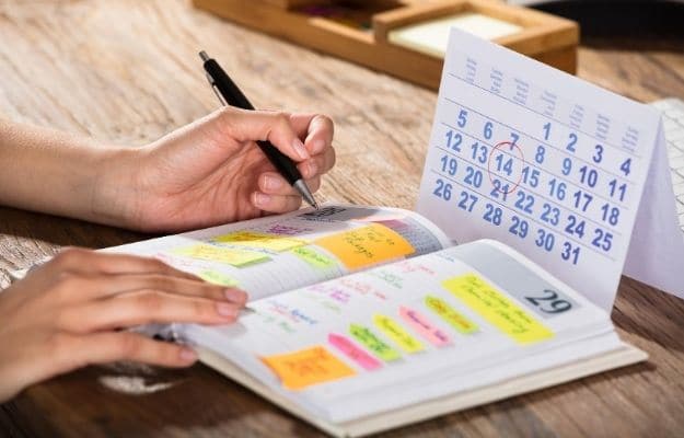 A woman creating working schedule ca