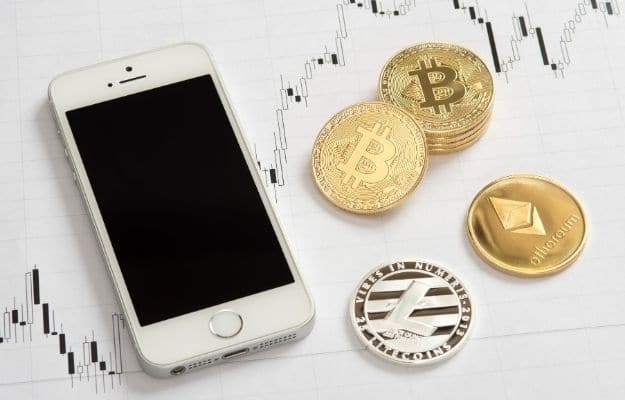 different types of coins present for cryptocurrency and a phone CA