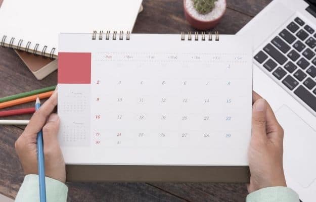 one person is holding a table calendar | October 1, 2020 – Deadline for Self-Employed to Set Up SIMPLE IRA | Important Fiscal Dates for H2 2020
