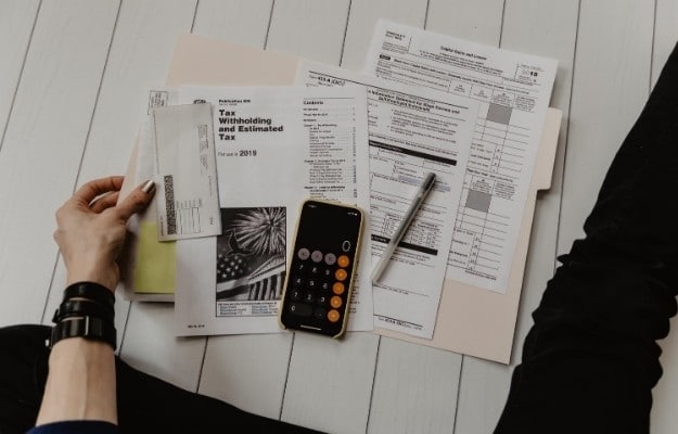 tax paper and calculator on the floor ca