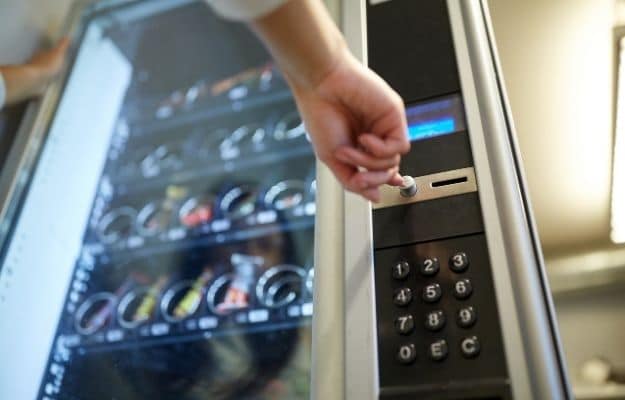 a men is using the vending machine ca