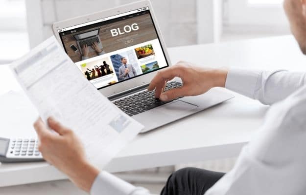 businessman with internet blog page on laptop computer screen | Blog Regularly | How to Expand Your Business Reach