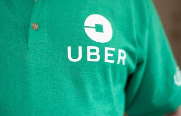 erson wearing a green polo shirt with a white Uber logo ss