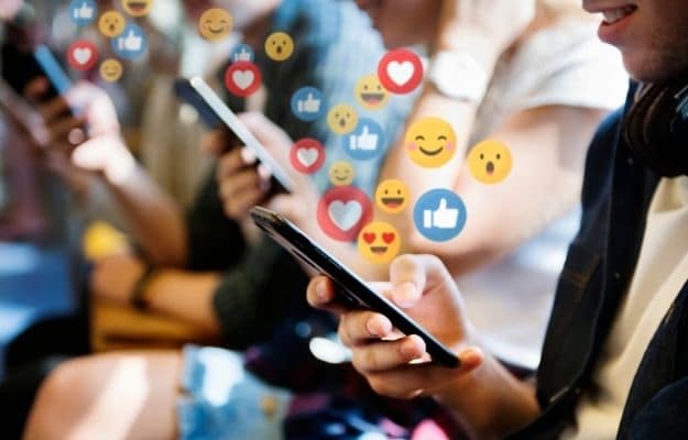 people holding phones with many emoji | Helps Businesses Create Associations | How Social Media Can Transform Your Business