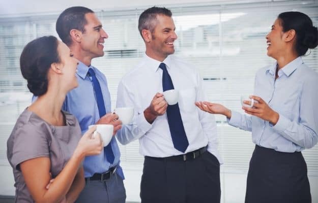 Cheerful work team during break time in bright office ss